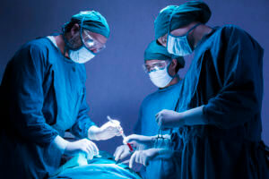 Concentrated professional surgical doctor team operating surgery a patient in the operating room at the hospital