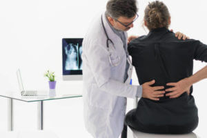 Physical Doctor consulting with patient about Back problems Physical therapy