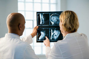 Male and female doctor looking at patient xray film.